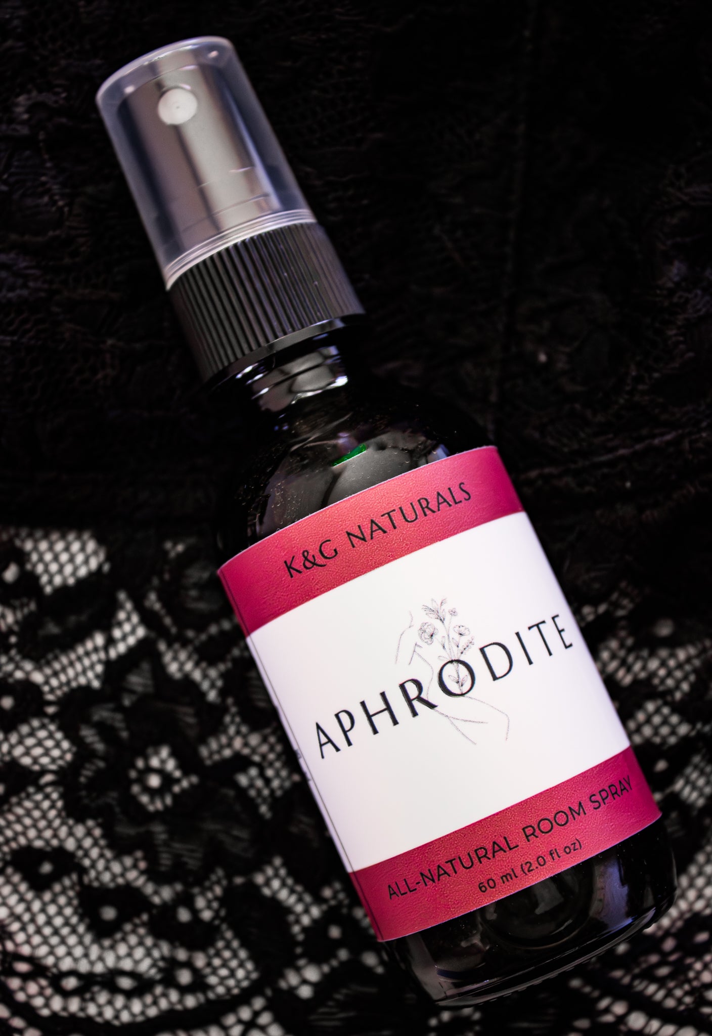 Bottle of K&G Naturals Aphrodite all-natural room spray on a black lacy background