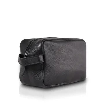 A black pebbled leather cosmetic pouch with a zippered main compartment and a side strap, shown on a white background with a soft reflection.