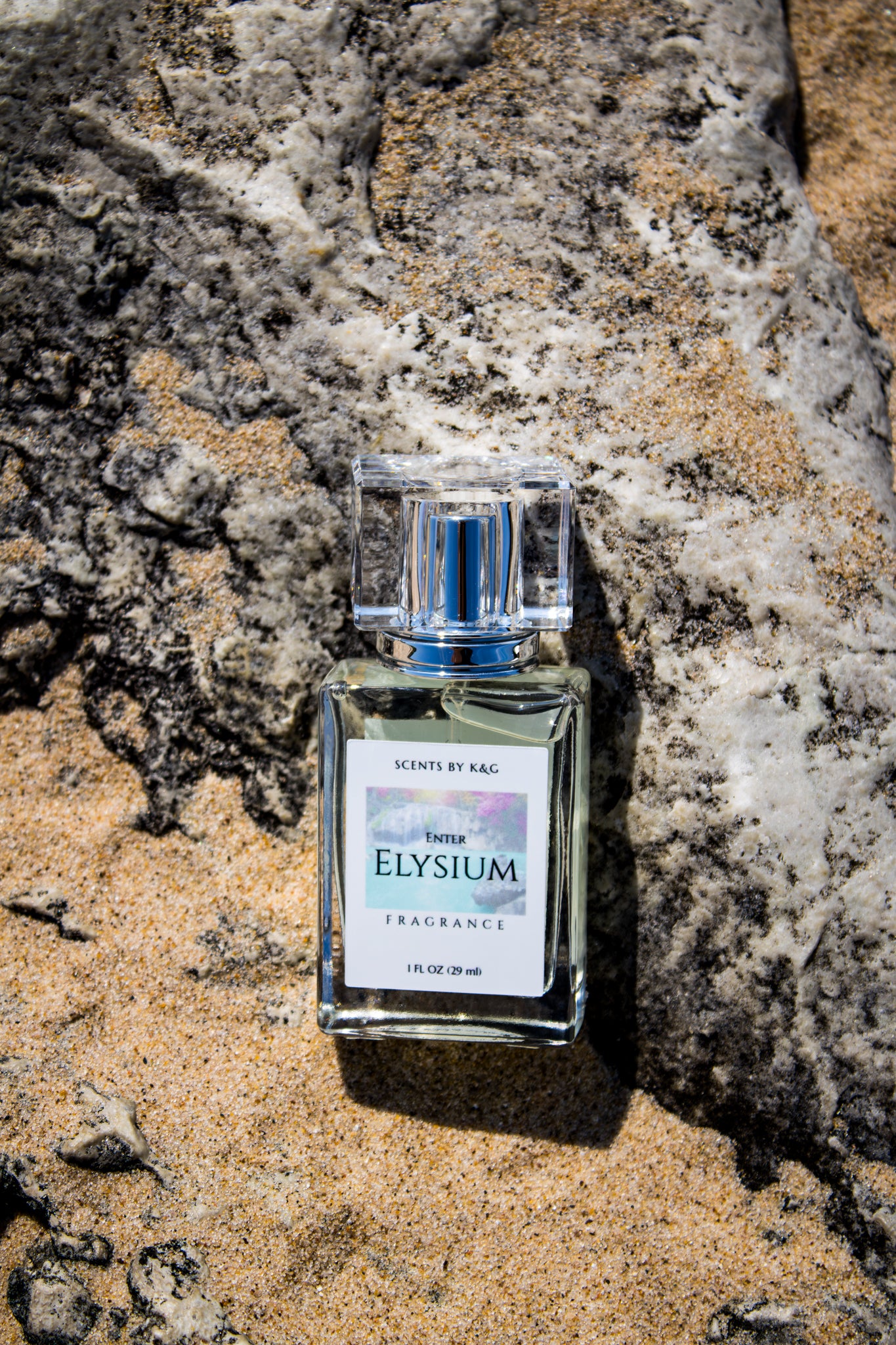 Perfume bottle labeled 'Elysium' on a textured stone surface