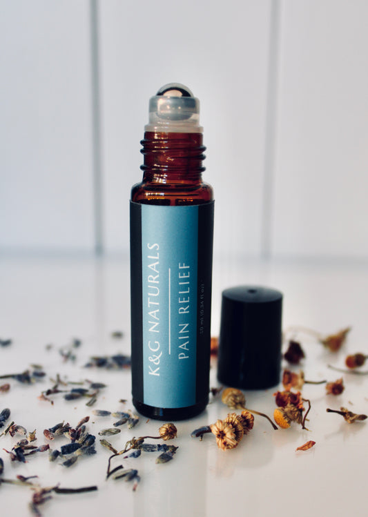 K&G Naturals Pain Relief roller bottle with dried flowers on a light background