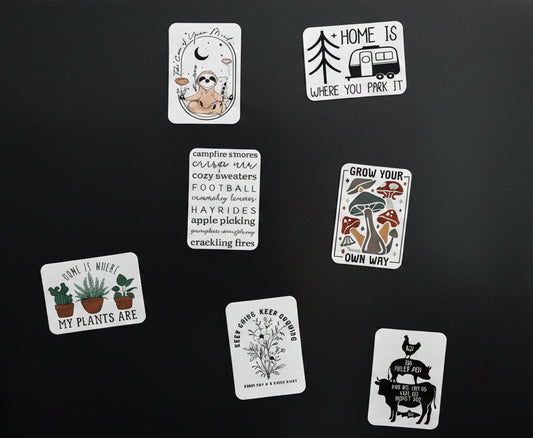 A variety of rectangular refrigerator magnets on a black background